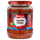 Bodrum Mild Pepper Paste (700g) with red lid and label, made from high-quality peppers, features "Double Concentrated 28-30% BRIX 100% Natural." Ideal for marinades.